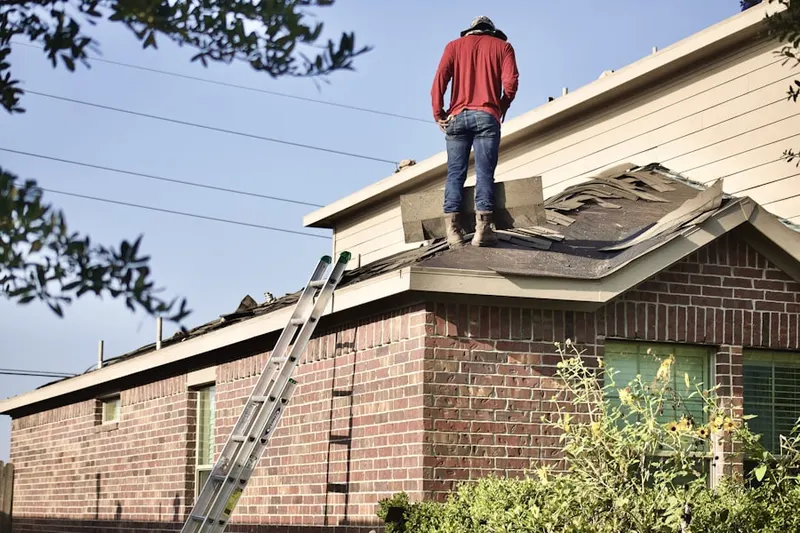 Professional roofer working on a residential roof in Treichlers